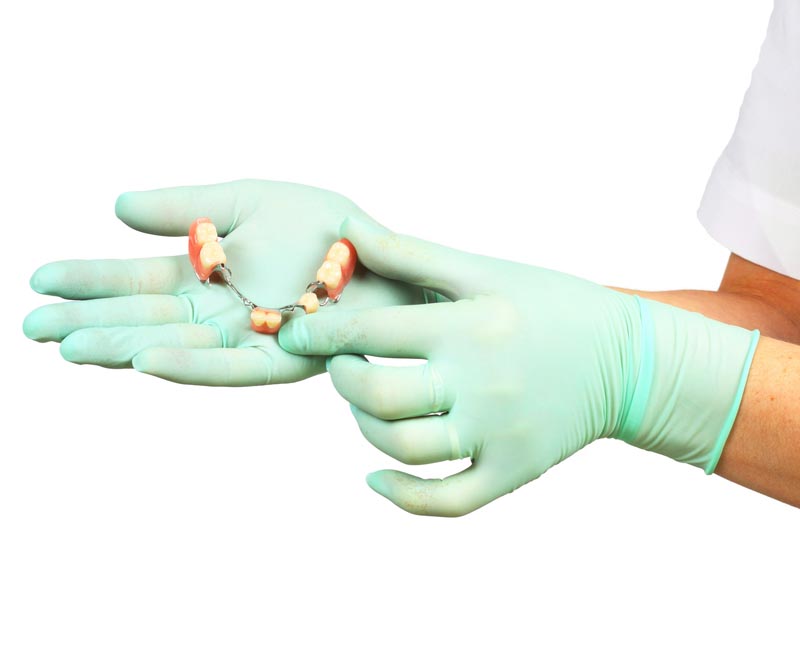 Denture, crown, bridge and veneers on hand Denture, crown, bridge and veneers on hand